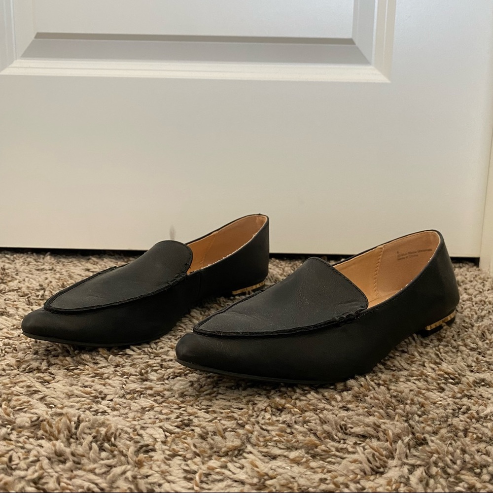 Express flats on black with gold accents, size 8